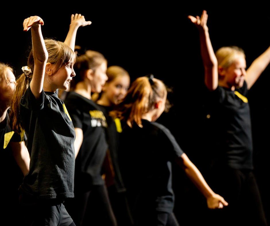 Teenagers performing on stage